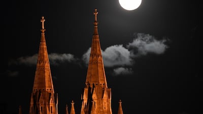 Shining brightly, the supermoon rises over Saint Peter's Cathedral in Adelaide, Australia. EPA