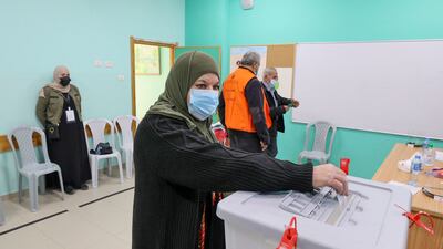 A woman casts her vote during municipal elections, in the village of Baitain, east of the occupied West Bank city of Ramallah. The previous municipal vote took place in 2017. AFP