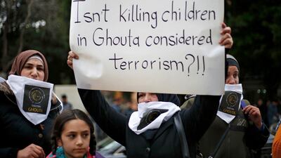 A Lebanese woman holds a placard during a protest in solidarity with residents of the Syrian capital's eastern suburb of Ghouta. Bilal Hussein / AP
