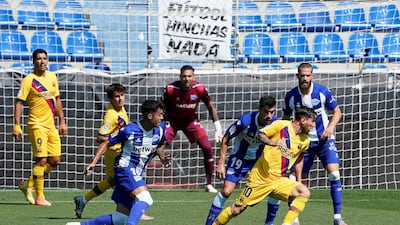 Lionel Messi on the ball as Alaves players try to close him down. Reuters