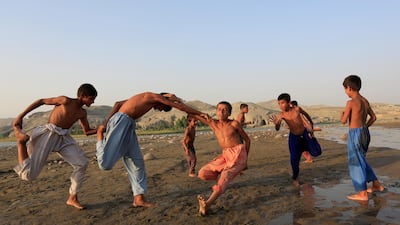 Afghan boys play on the outskirts of Jalalabad city, Afghanistan. Reuters