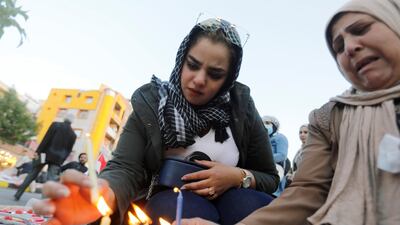 Demonstrators light up candles for people killed at an anti-government protest. Reuters