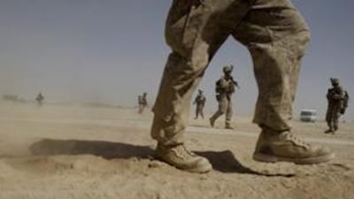 US Marines from the 2nd Marine Expeditionary Battalion walk through the sand inside Camp Leatherneck in Afghanistan's Helmand province Monday June 8, 2009.