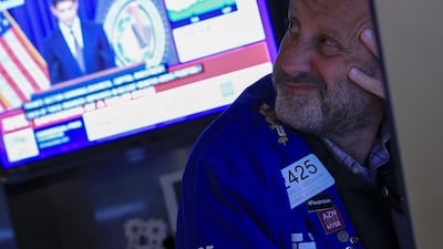 A trader looks on as US Federal Reserve Chair Kevin Warsh is displayed on a television screen on the floor of the New York Stock Exchange (NYSE) in New York on September 16, 2026. AFP