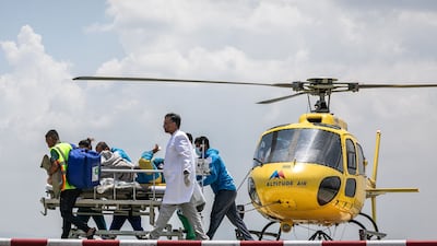 Medical staff receive Dawa Sherpa, who was missing for six days on Mount Everest, on the helipad at HAMS Hospital in Kathmandu, Nepal. AFP