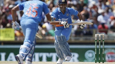 India's MS Dhoni, right, runs between wickets during their one day international cricket match against Australia, in Perth, Australia, Tuesday, Jan. 12, 2016. (AP Photo/Theron Kirkman)