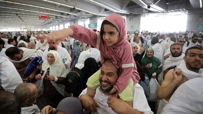 A ride on dad's shoulders during the ceremony at the Jamarat Bridge. EPA