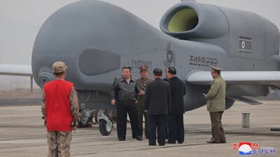 North Korea's leader Kim Jong Un inspecting what appears to be a reconnaissance drone at an undisclosed location in the country. EPA