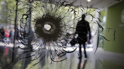 A bullet hole in a shop window of the Champs Elysees boulevard in Paris, Friday, April 21, 2017, the day after another deadly shooting claimed by ISIL. Christophe Ena / AP