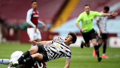 United's Harry Maguire goes down injured after clashing with Anwar El Ghazi of Villa. AP