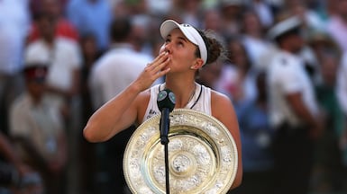LONDON, ENGLAND - JULY 11: Linda Noskova of Czechia blows a kiss as she holds the Venus Rosewater Dish as she is interviewed on court after victory against Karolina Muchova of Czechia in their Ladies' Singles final match on day thirteen of The Championships Wimbledon 2026 at All England Lawn Tennis and Croquet Club on July 11, 2026 in London, England. (Photo by Matthew Stockman / Getty Images)