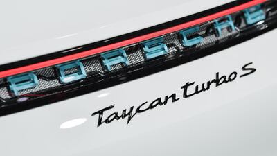 The logo of a Porsche Taycan turbos S electric car is seen during its presentation. AFP