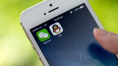 The icons for Tencent’s messaging applications WeChat, left, and QQ are displayed on an Apple smartphone. Brent Lewin / Bloomberg