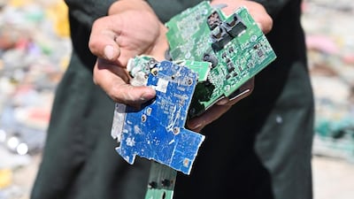 A man shows electronic motherboards at a junkyard near the Bagram Air Base. AFP