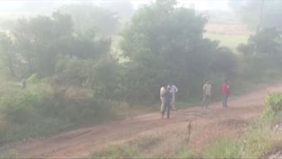 A still frame taken from a December 6, 2019 video shows various policemen and officials standing at a spot where police shot dead four men suspected of raping a veterinary doctor, in Hyderabad. ANI via Reuters