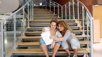 Jess Verdon, 17, discusses her exam results with her mother Nettie Verdon on Thursday at the British School Al Khubairat.