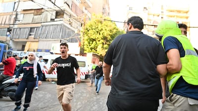 People rush to the site of thge strike on an apartment building. AFP