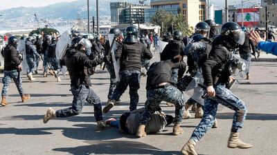 Lebanese riot police beat a fallen anti-government protester during clashes in a demonstration in the centre of the Lebanese capital Beirut. AFP