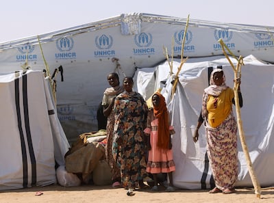 Sudanese refugees stand in front of a makeshift tent in eastern Chad. Reuters
