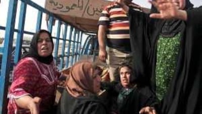 Mourners with bodies of relatives killed outside Baghdad, apparently targeted for turning against al Qa'eda.