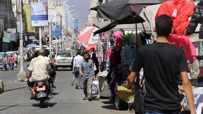 People walk in a market street in Yemen's southwestern city of Taez on November 13, 2018. AFP