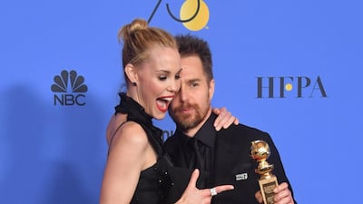 Leslie Bibb poses with actor Sam Rockwell and his award for Best Performance. AFP
