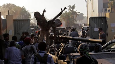 Rebel fighters gesture inside the main Moammar Gadhafi compound in Bab Al-Aziziya in Tripoli, LIbya, Tuesday, Aug. 23, 2011. Libyan rebels stormed Moammar Gadhafi's main military compound in Tripoli Tuesday after fierce fighting with forces loyal to his ???