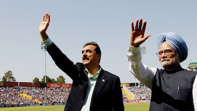 Mr Singh and Pakistan's then prime minister Yusuf Raza Gilani ahead of the World Cup cricket semi-final between India and Pakistan in Mohali, northern India, in 2011. Reuters