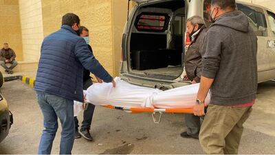 Families of the victims wait outside the morgue to collect the bodies of their loved ones.