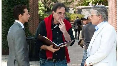 Oliver Stone, centre, gives directions to Michael Douglas, right, and Shia LaBeouf on the set of Wall Street: Money Never Sleeps.