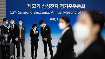 Event staff wear protective masks during the Samsung Electronics Co. annual general meeting at the Suwon Convention Center in Suwon, South Korea. Bloomberg