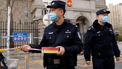 Police officers set up a perimeter outside the Beijing No 2 Intermediate People's Court where Michael Kovrig, a Canadian detained by China in December 2018 on suspicion of espionage, went on trial on March 22, 2021. Reuters