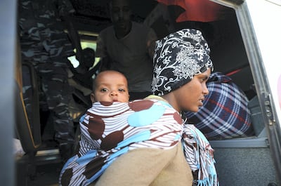 Migrants are seen after they were relocated from government-run detention centres, after getting trapped by clashes between rival groups in Tripoli. Reuters