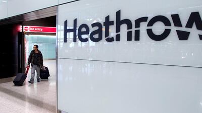 A passenger arrives at Heathrow airport in London. The airport is to reopen Terminal 3 on July 15. Andrew Cowie / EPA
