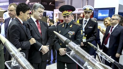 Ukrainian president Petro Poroshenko, third left, and the head of Ukrainian General Staff Viktor Muzhenko, right of Poroshenko, visit the International Defence Exhibition and Conference. Mikhail Palinchak / AP Photo