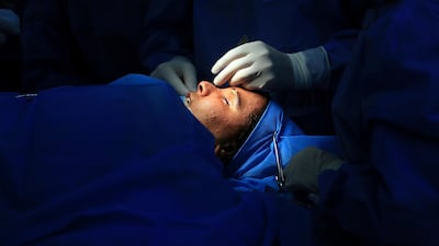 Dr Abbas Al Sahan performs reconstructive surgery on Saja Ahmed Saleem, in Baghdad, Iraq. AP