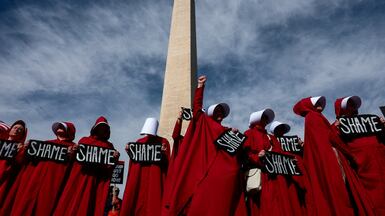 Demonstrators dressed as handmaidens from 'The Handmaid's Tale' take part in an anti-Trump protest in Washington to mark one year since the re-election of US President Donald Trump. Reuters