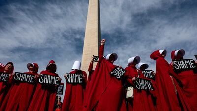 Demonstrators dressed as handmaidens from 'The Handmaid's Tale' take part in an anti-Trump protest in Washington to mark one year since the re-election of US President Donald Trump. Reuters