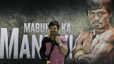 Pacquiao poses for the media following a news conference upon arrival at the Ninoy Aquino International Airport at suburban Pasay city south of Manila, Philippines. Bullit Marquez / AP Photo