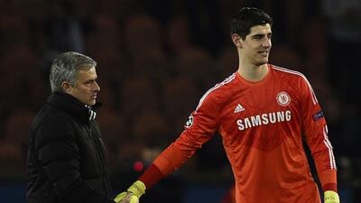 Jose Mourinho, left, shakes hands with his goalkeeper, Thibaut Courtois after the Belgian produced a string of saves to help Chelsea to a draw against Paris Saint-Germain. Franck Fife / AFP