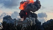 (FILES) A fireball and smoke erupt from a building following an Israeli strike in Tyre, southern Lebanon, on May 28, 2026. The world has settled in a high level of violence with, in 2025, the largest number of state conflicts since the end of World War II and an explosion of attacks directly targeting civilians, according to the annual PRIO Global Conflict Trends report on the trend of conflicts in the world published on June 9, 2026. (Photo by KAWANT HAJU / AFP)