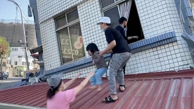 A child is rescued from a partially collapsed building in Hualien. AP