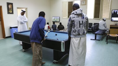 Social supervisor Khalifa Al Madhani watches as young men use the recreation room at the Young Men Social Foster Home in Fujairah. Sarah Dea / The National