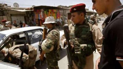 Iraqi soldiers and US marines stop a young man who was driving erratically through a crowded marketplace in the troubled Basra neighbourhood of Hayaniya.