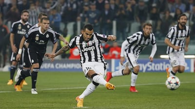 Carlos Tevez of Juventus shoots and scores his penalty kick for the 2-1 winner against Real Madrid in the first leg of their Champions League semi-final first leg match on Tuesday. Sergio Perez / Reuters