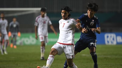 Japan's Taishi Matsumoto, right, fights for a ball with the UAE's Ahmed Al Hashmi. AFP
