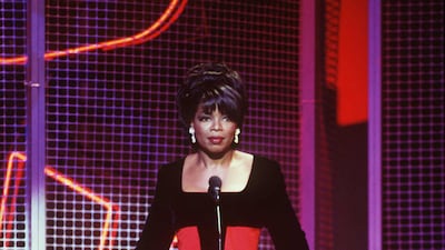 Oprah Winfrey wears a red-and-black gown to attend 'Ebony Magazine' Celebrate the Dream: 50 Years of Ebony Magazine event on November 17, 1997. Getty Images
