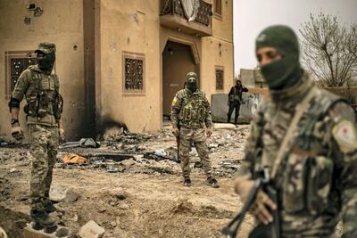 Members of the Syrian Democratic Forces (SDF) walk in the village of Baghouz in Syria's eastern Deir Ezzor province near the Iraqi border a day after the ISIS was declared defeated. AFP