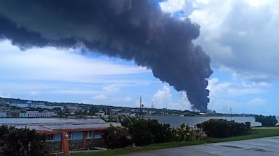 A column of smoke rises from a fire at a fuel depot in Matanzas, Cuba. According to the authorities, 17 firefighters have gone missing while tackling the blaze. EPA