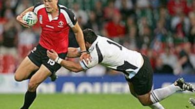 Canada's Mike Pyke, left, runs with the ball during the Rugby World Cup match between Fiji and Canada back in 2007. Pyke is set for his AFL debut.